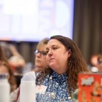 person at table listening photo 3